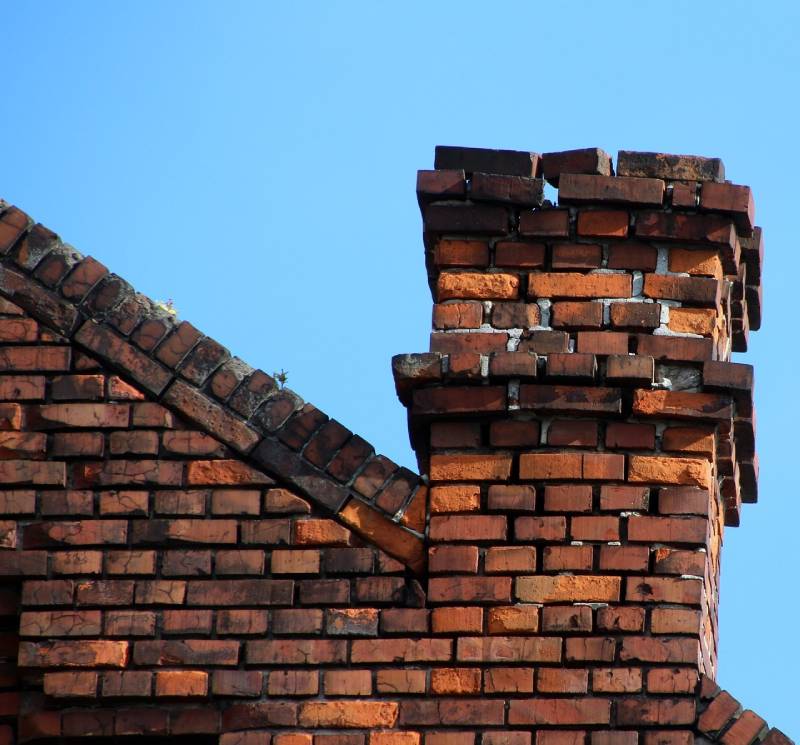 Damaged chimney on an Ayer home showing cracks and missing mortar